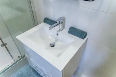 a bathroom with a white sink and a shower at Cocon T2 dans le centre d'Aix in Aix-en-Provence