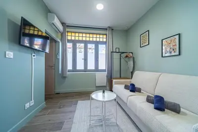 a living room with a couch and a table at Studio raffiné - Aix hypercentre in Aix-en-Provence
