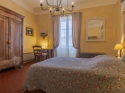 a bedroom with a bed and a window and a mirror at Holiday Home Côté Place by Interhome in Villars