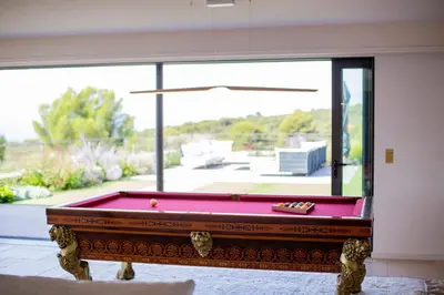 a pool table in a room with a large window at Luxury 4-bedroom villa - pool in Gordes