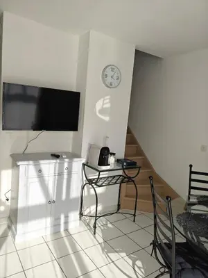 a living room with a tv and a table and chairs at Casa Luma in Saint-Saturnin-les-Avignon