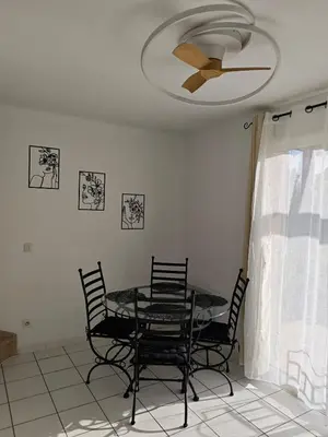 a dining room table with chairs and a ceiling fan at Casa Luma in Saint-Saturnin-les-Avignon