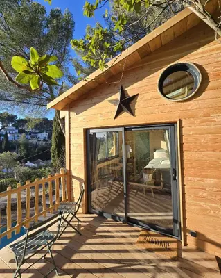 a wooden cabin with a star on the roof at La Cabane Aixoise Piscine & Jacuzzi in Aix-en-Provence
