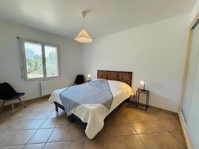 a bedroom with a bed in a room with a window at Villa dans le Luberon in Saint-Saturnin-les-Apt