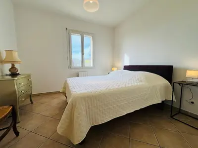 a bedroom with a white bed and a window at Villa dans le Luberon in Saint-Saturnin-les-Apt