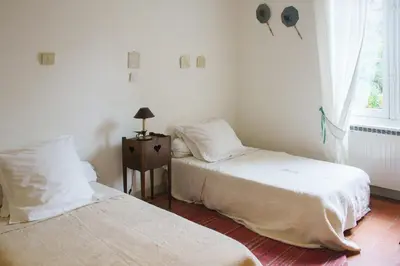 a bedroom with two beds and a window at Holiday Home in Lourmarin Stunning View of the Château in Lourmarin