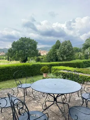 a table and chairs with a view of a garden at Holiday Home in Lourmarin Stunning View of the Château in Lourmarin