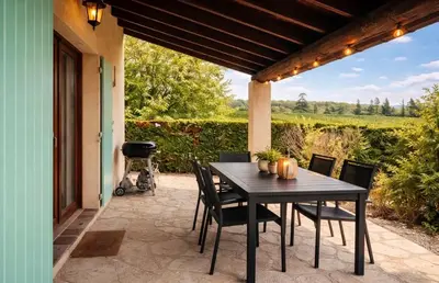 a table and chairs on a patio with a view at Maison du Ventoux in Mormoiron