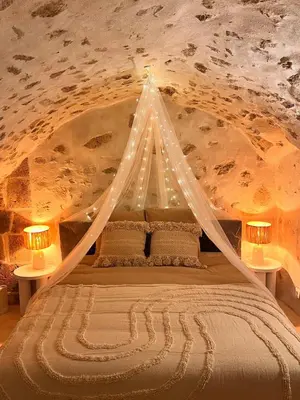 a jacuzzi tub with candles in a room at Les Caves d 'Oía in Aix-en-Provence