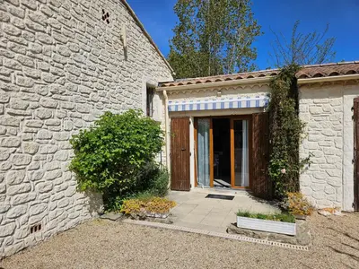 a stone house with a door and a building at Chez Cathy in Pernes-les-Fontaines