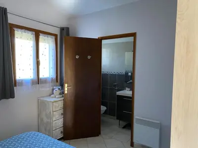 a bedroom with a bathroom with a sink and a toilet at Chez Cathy in Pernes-les-Fontaines