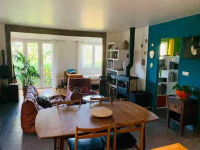 a living room with a table and a couch at Le Mas St Pierre in Aix-en-Provence