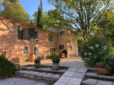 a house with potted plants in front of it at Le Mas St Pierre in Aix-en-Provence