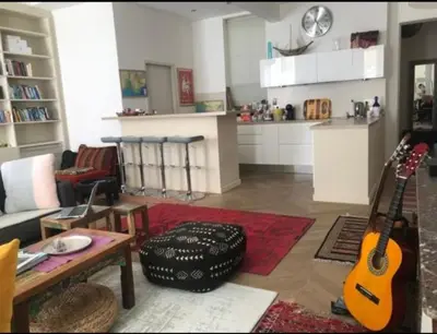 a living room with a guitar and a table at 100m2 beautiful appartment in Aix City Center in Aix-en-Provence