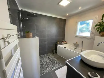 a bathroom with a sink and a bath tub at Zen house with a view in Manosque
