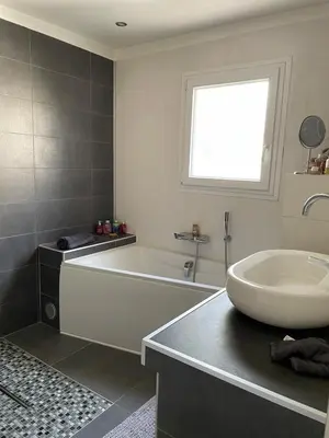 a bathroom with a bath tub and a sink at Zen house with a view in Manosque