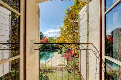 an open balcony with a view of a yard at MAS DES CIGALES Lambesc in Lambesc