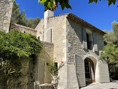 a stone house with a gate and a patio at MAS DES CIGALES Lambesc in Lambesc