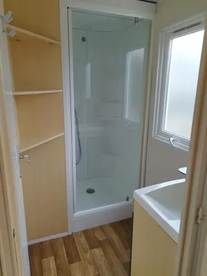 a bathroom with a shower with a glass door at Comme Chez Vous Au Camping Des Iscles in La Roque-dʼAnthéron