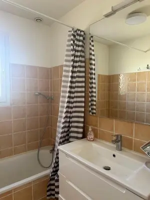 a bathroom with a sink and a shower and a mirror at At Tinou's spacious quiet house with garden for 2 people in LʼIsle-sur-la-Sorgue