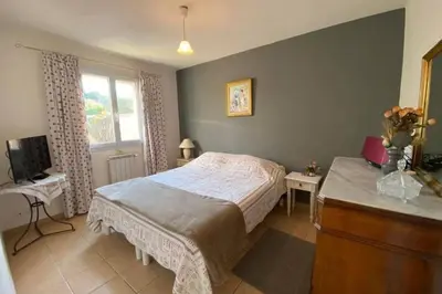 a bedroom with a bed and a dresser and a television at At Tinou's spacious quiet house with garden for 2 people in LʼIsle-sur-la-Sorgue