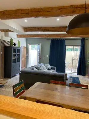 a living room with a couch and a table at Maison du soleil in Caumont-sur-Durance