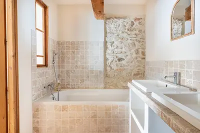 a bathroom with a tub and a sink at Mas de 190m2 Climatisé avec Piscine et Cuisine d'été - 10 pers in La Fare-les-Oliviers