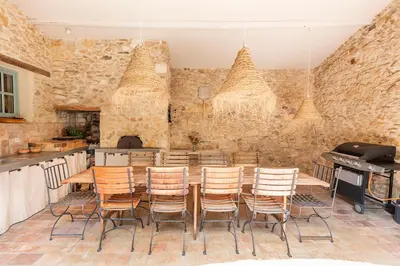 a dining room with a table and chairs at Mas de 190m2 Climatisé avec Piscine et Cuisine d'été - 10 pers in La Fare-les-Oliviers