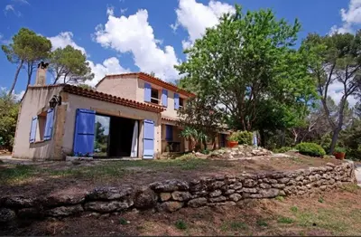 an old house with a stone wall at Villa Martine, authentic family home in Rognes