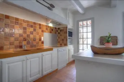 a large kitchen with a wooden bowl on a counter at Villa Martine, authentic family home in Rognes