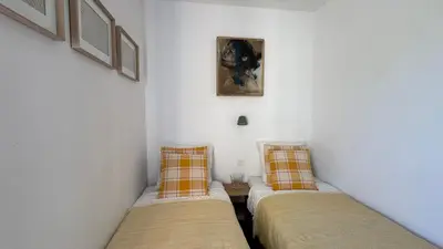 two beds in a room with white walls at Greens View golf saumane in Saumane-de-Vaucluse