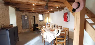 a kitchen and dining room with a table and chairs at 15 rue des pierres seches in Ferrassières