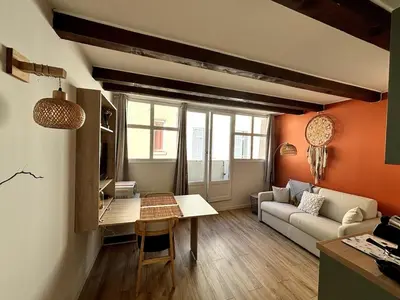a living room with a couch and a table at Studio lumineux centre Aix en Provence in Aix-en-Provence