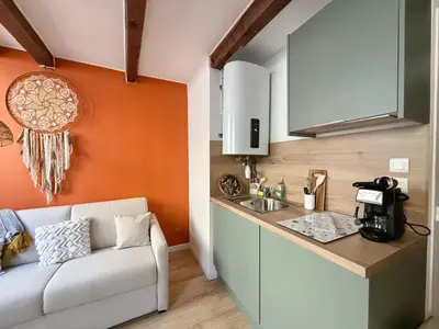 a kitchen with a couch next to a sink at Studio lumineux centre Aix en Provence in Aix-en-Provence