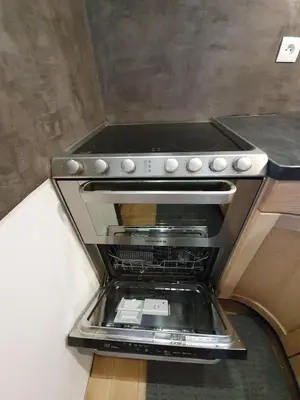 a stove top oven sitting in a kitchen at Appartement atypique dans un ancien couvent in LʼIsle-sur-la-Sorgue