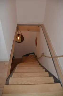 a staircase in a loft with a light fixture at Maison en coeur de ville in LʼIsle-sur-la-Sorgue