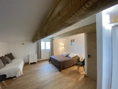 a large bedroom with a bed at Pavillondulantana in Les Taillades