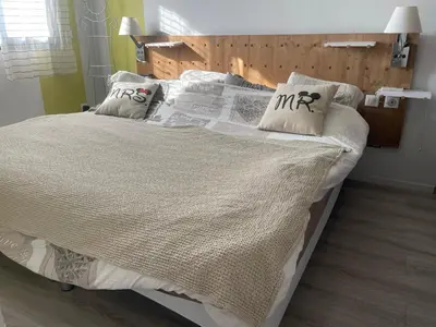 a bed with white sheets and pillows on it at Villa entière piscine jacuzzi venelles in Venelles