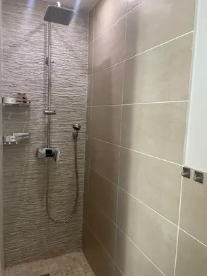 a bathroom with a shower with a shower head at Villa entière piscine jacuzzi venelles in Venelles