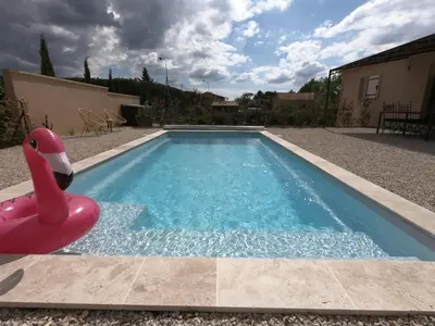 three towels stacked on top of each other with a plant at La Villa Elissia en Luberon in Saint-Saturnin-les-Apt