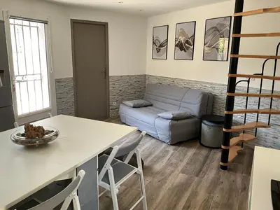 a living room with a couch and a table at Le petit bastidon gîte à Oppède avec piscine in Oppède