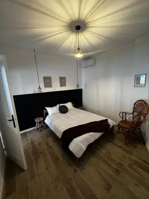 a bedroom with a large bed and a ceiling at Élégant T2 proche gare et centre in Miramas