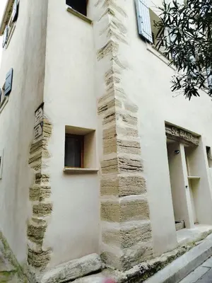 a building with stone steps on the side of it at Charmant Appartement en Provence in Caromb