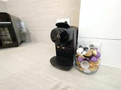 a coffee maker sitting next to a cup of candy at Charmant Appartement en Provence in Caromb