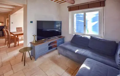a living room with a couch and a flat screen tv at Awesome Home In Goult With Wifi in Goult