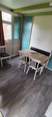 a wooden table and two chairs in a room at Chalets dans le Luberon in Viens