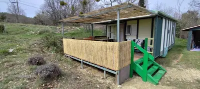 a small house with a porch and a deck at Chalets dans le Luberon in Viens