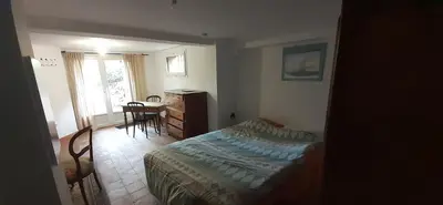 a bedroom with a bed and a desk and a table at Studio indépendant au calme proche d'Aix en Provence in Aix-en-Provence