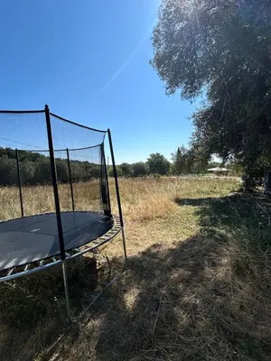 a trampoline in the middle of a field at Authentique mas provençal avec piscine in Beaumont-de-Pertuis