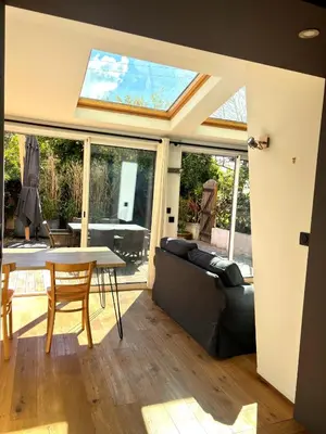 a living room with a couch and a table at Paul Cézanne garden apartment with air conditioning in Aix-en-Provence